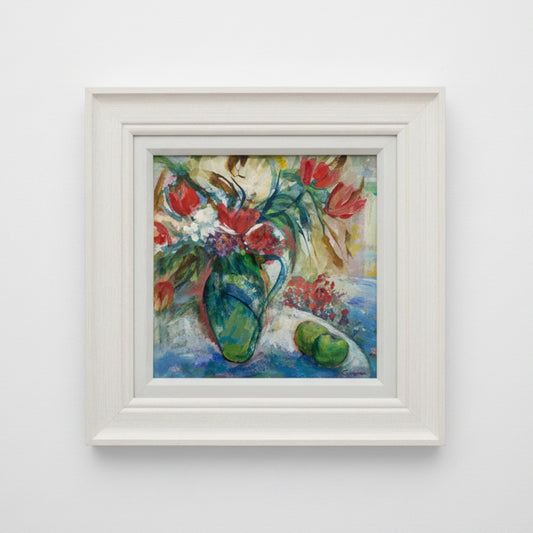 Framed painting of a colorful still life with flowers and a vase on a white wall.