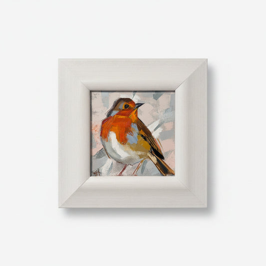 Framed artwork of a bird on a textured white wall