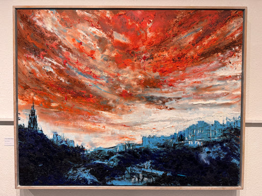Artistic depiction of an Edinburgh cityscape with a dramatic red and orange sky, framed on a wall.