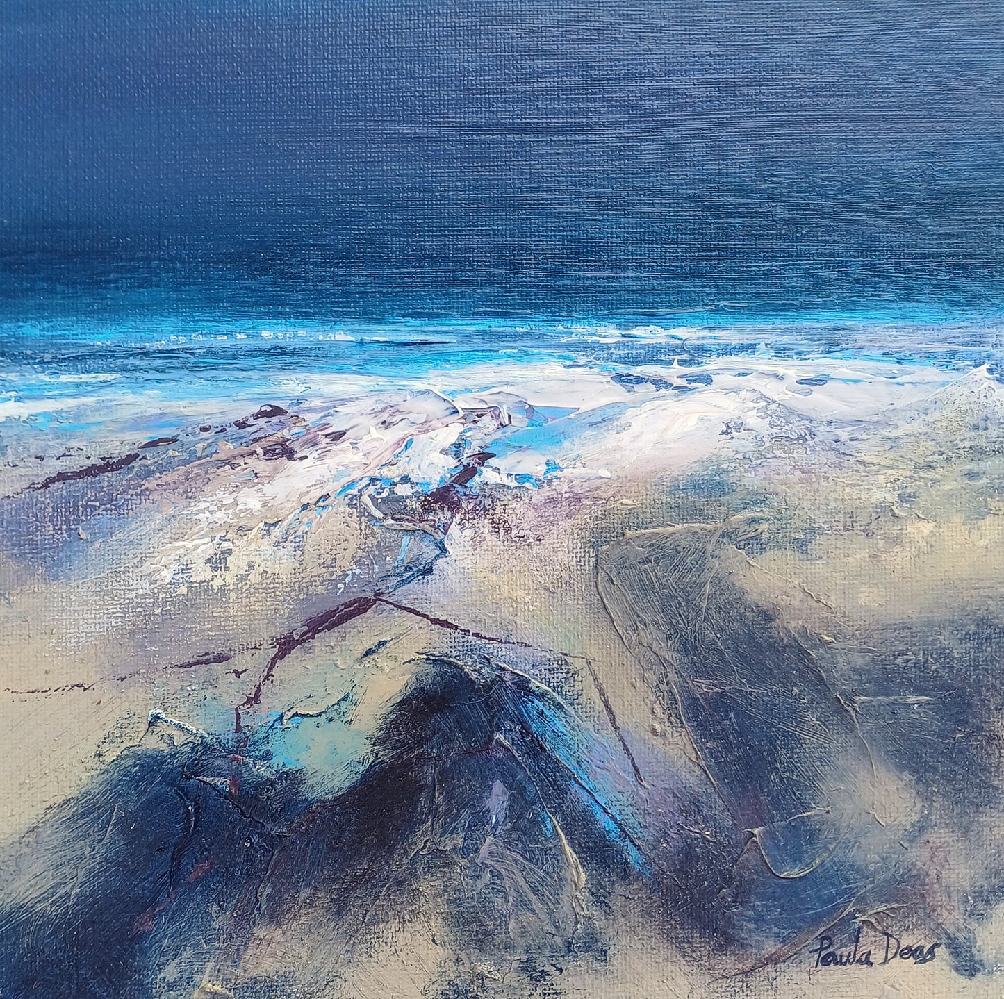 An abstract coastal landscape painting featuring a deep blue ocean under a dark blue sky, with white surf and textured sandy shore in beige, gray, and blue tones. Signed 'Paula Doss' in the bottom right corner.