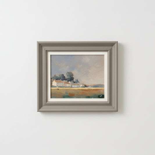 Framed painting of a landscape on a white wall