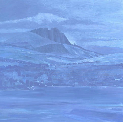 Mountain landscape with a large rock formation in a blue-tinted setting