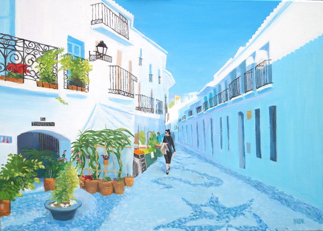 Tropical street scene with white buildings, potted plants, and a person walking.