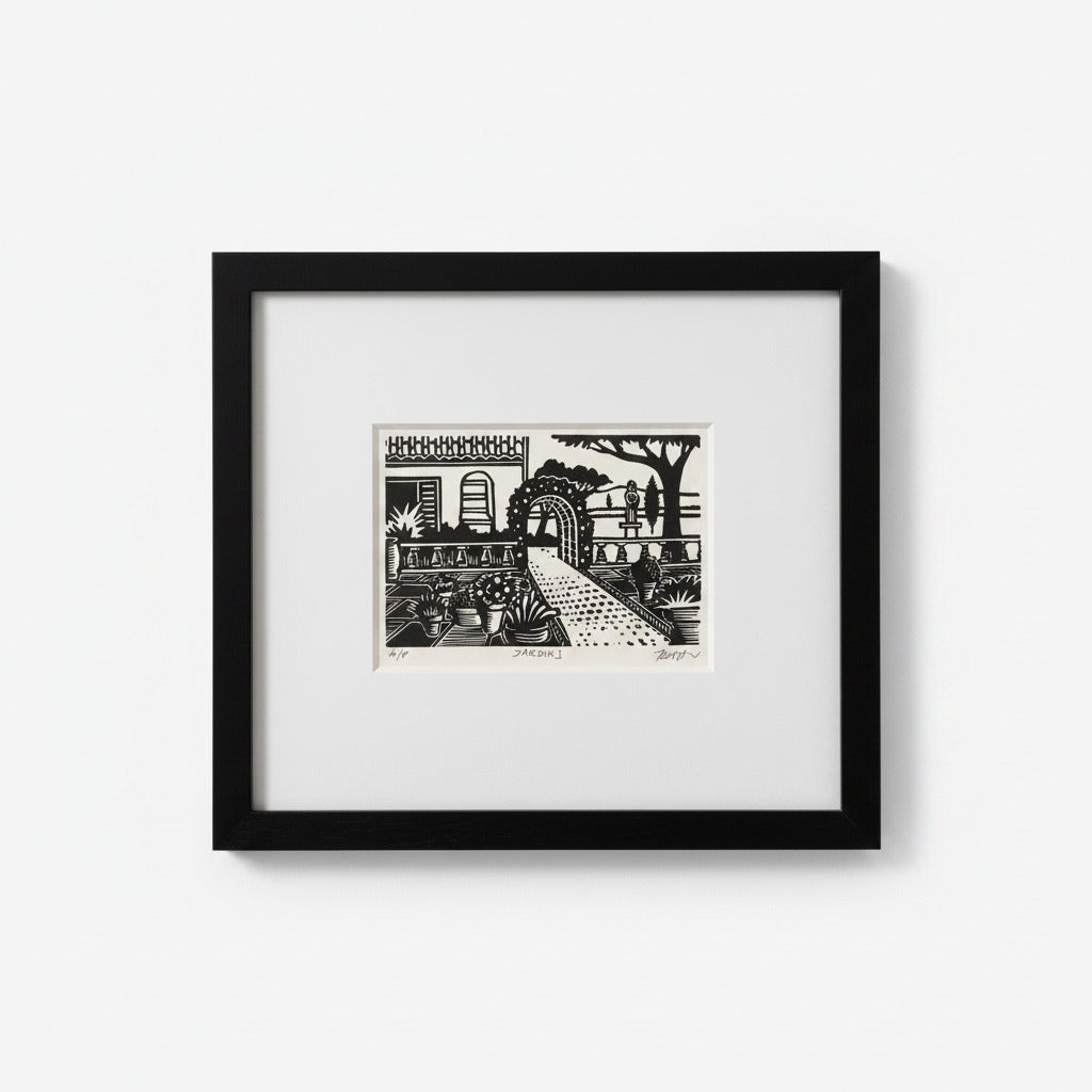 A framed black and white art print depicting a stylized garden scene with a path, trees, and architectural details, set in a black frame with a white mat against a light gray background.