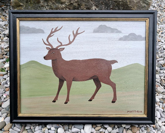 Framed artwork of an Stag on a green background with a blue sky.