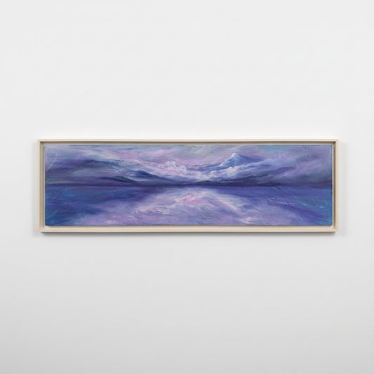 Framed artwork of a landscape with purple and blue hues on a white background