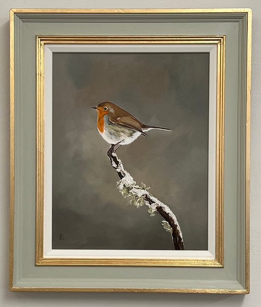 Framed painting of a robin on a branch with a gold frame.