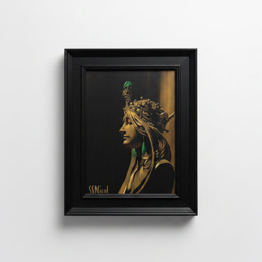 Framed artwork of a stylized portrait with intricate headpiece on a dark background