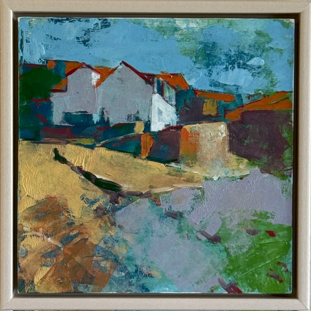 An abstract landscape painting of coastal houses and a stream, presented in a square light wood frame. The artwork features textured impasto brushstrokes in blue, green, white, gold, orange, and purple.