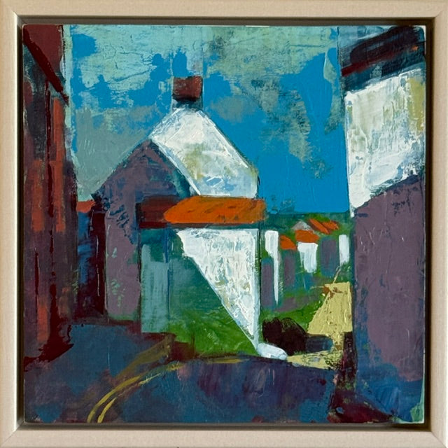 An abstract expressionist painting of a village street scene, featuring houses with white walls and orange roofs under a bright blue sky, enclosed in a light beige frame.