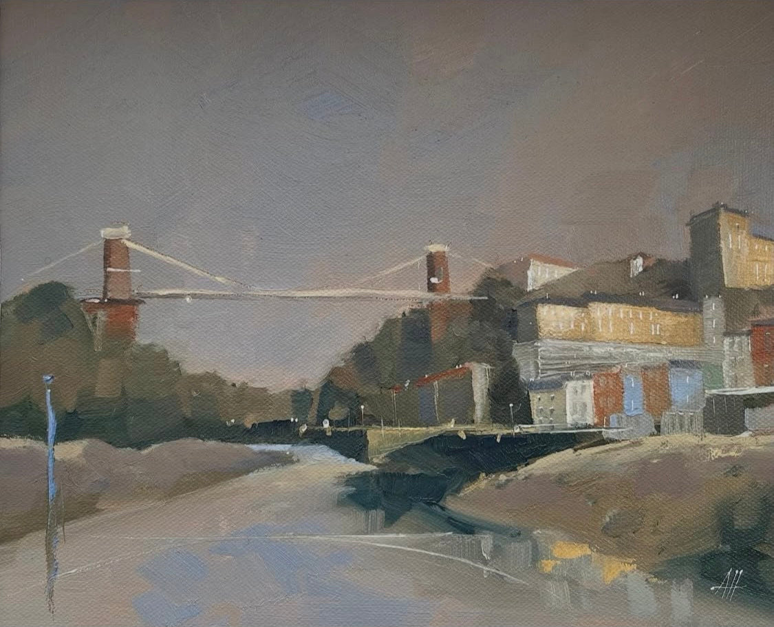 Oil on Board Painting of a gorge with a suspension bridge across the water, and also some colourful buildings on the right hand side. Painted by Alex Hinge and sized at 36 x 32cm framed.