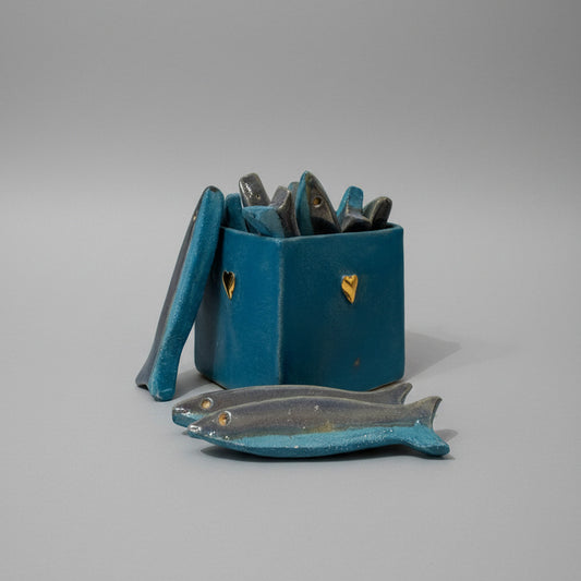 Blue ceramic box with a collection of fish on a white background