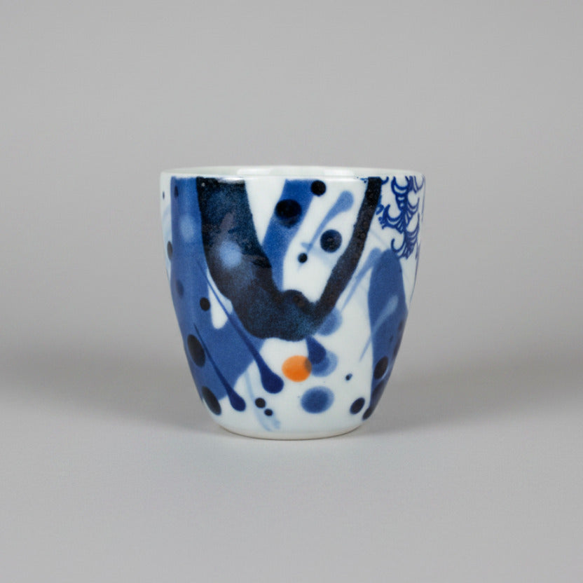 Ceramic piece with blue and white patterns on a white surface