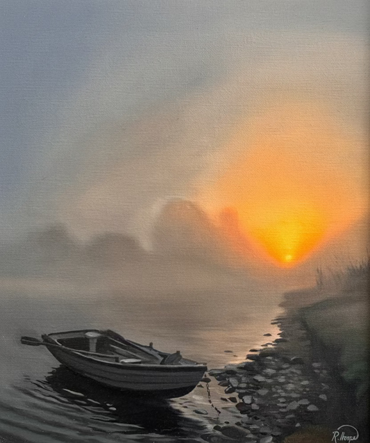 A framed landscape painting depicting a calm misty waterway at sunrise or sunset, with a small boat on the left and a bright orange sun over the horizon. The artwork is housed in a light-colored wooden frame.