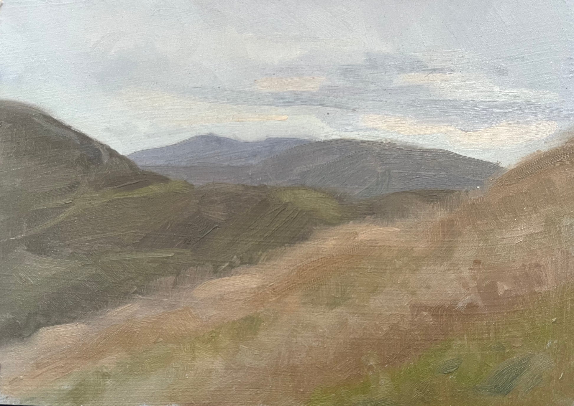 An oil painting of a hazy mountain landscape with rolling hills in muted shades of brown, green, and gray under a cloudy sky.