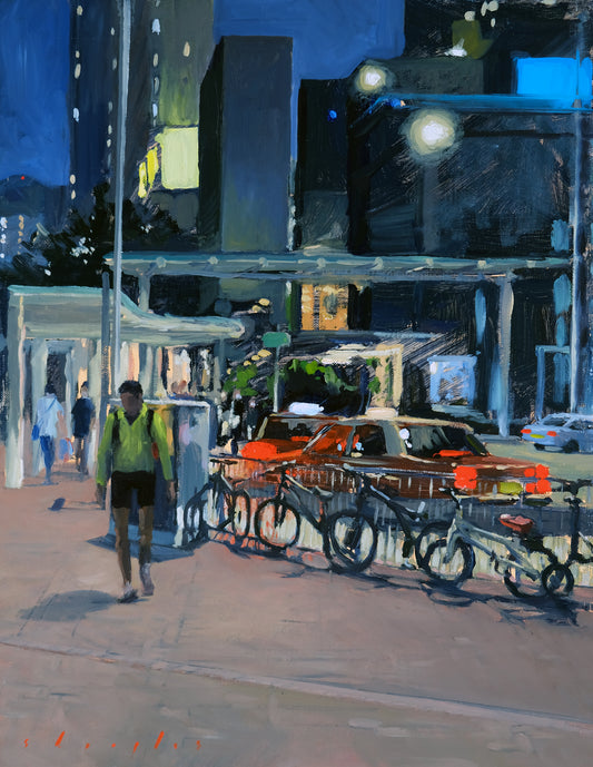 City street scene with people, cars, and a truck at night.