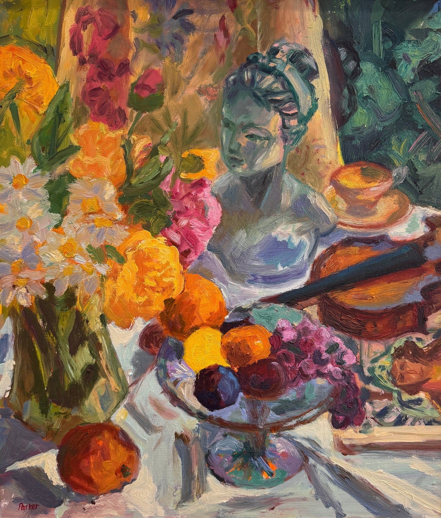A framed still life oil painting displayed on a wooden easel. The painting features a vibrant arrangement of flowers, fruit, and a violin with a blue-toned bust in the background.