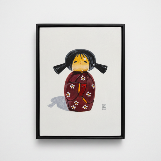 Framed artwork of a traditional Japanese doll on a white background