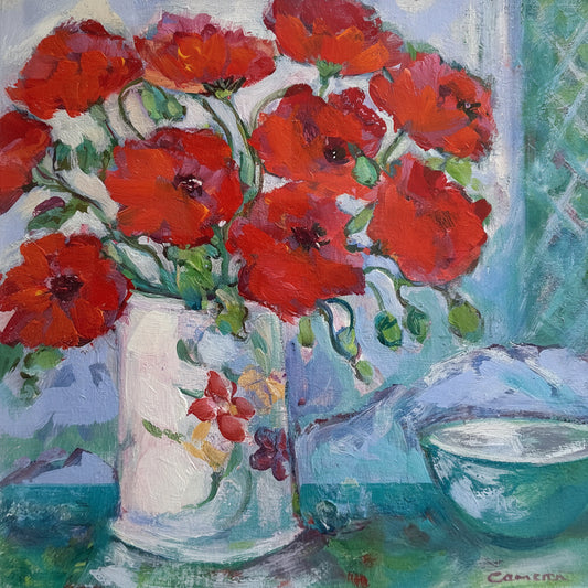 Framed artwork with red floral design on a textured wall