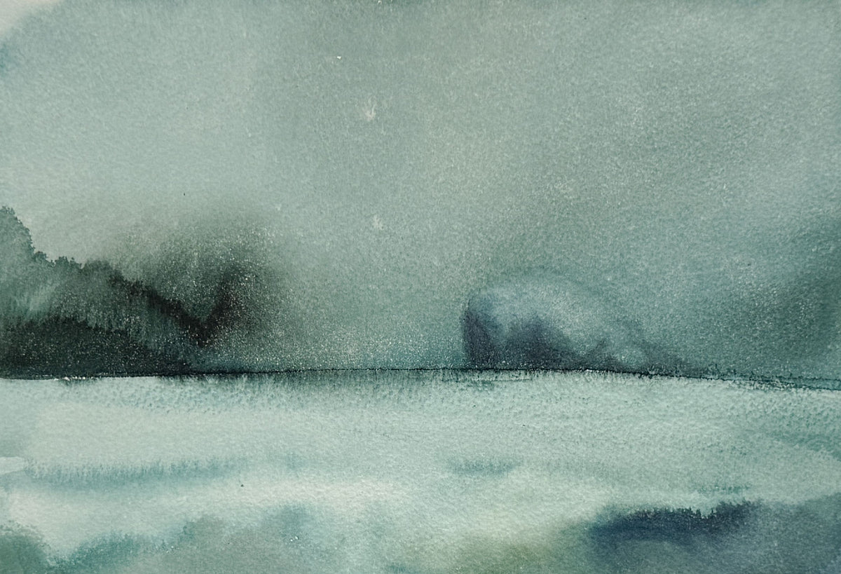 A watercolor landscape painting featuring a misty, atmospheric seascape with dark silhouetted landforms on the left and a soft, rounded rock or island shape on the right, rendered in muted blue-green, gray, and white tones.
