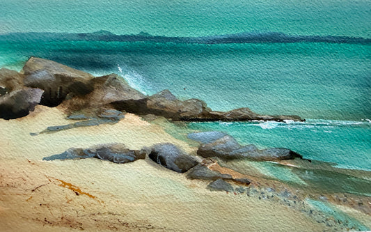Watercolor painting of a tropical beach scene with turquoise ocean water, dark rocky shoreline, and pale sandy beach.
