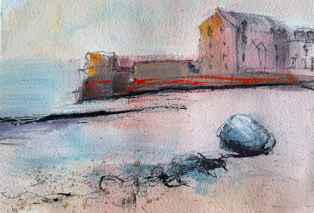A watercolor and ink sketch of a coastal scene with a pale pink building, blue water, and a dark blue rock in the foreground on textured paper.
