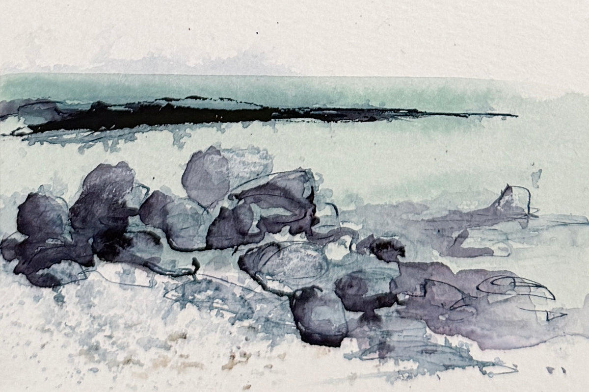 A minimalist watercolor painting of a rocky shoreline, featuring dark charcoal and slate gray rocks in the foreground, a pale greenish-gray sea, and a light off-white sky.