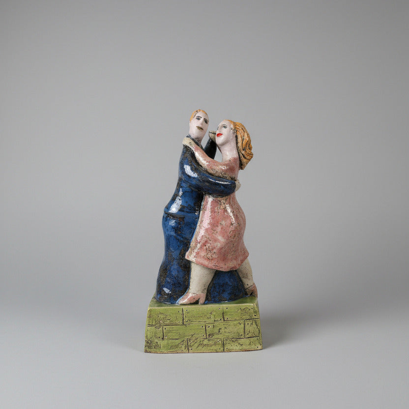  ceramic figurine of a couple on a white surface