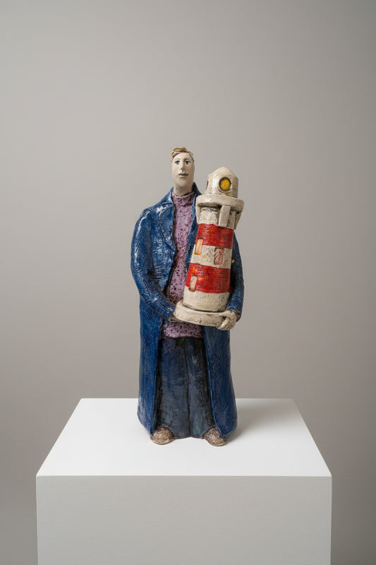 figure holding a lighthouse on a textured white surface