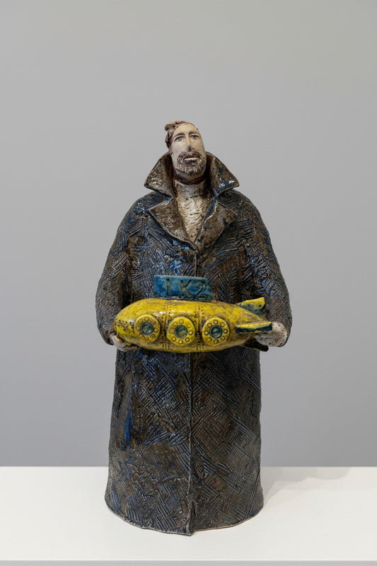 Ceramic figure with a yellow submarine on a white background