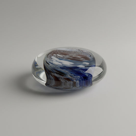 Round glass paperweight on a textured surface