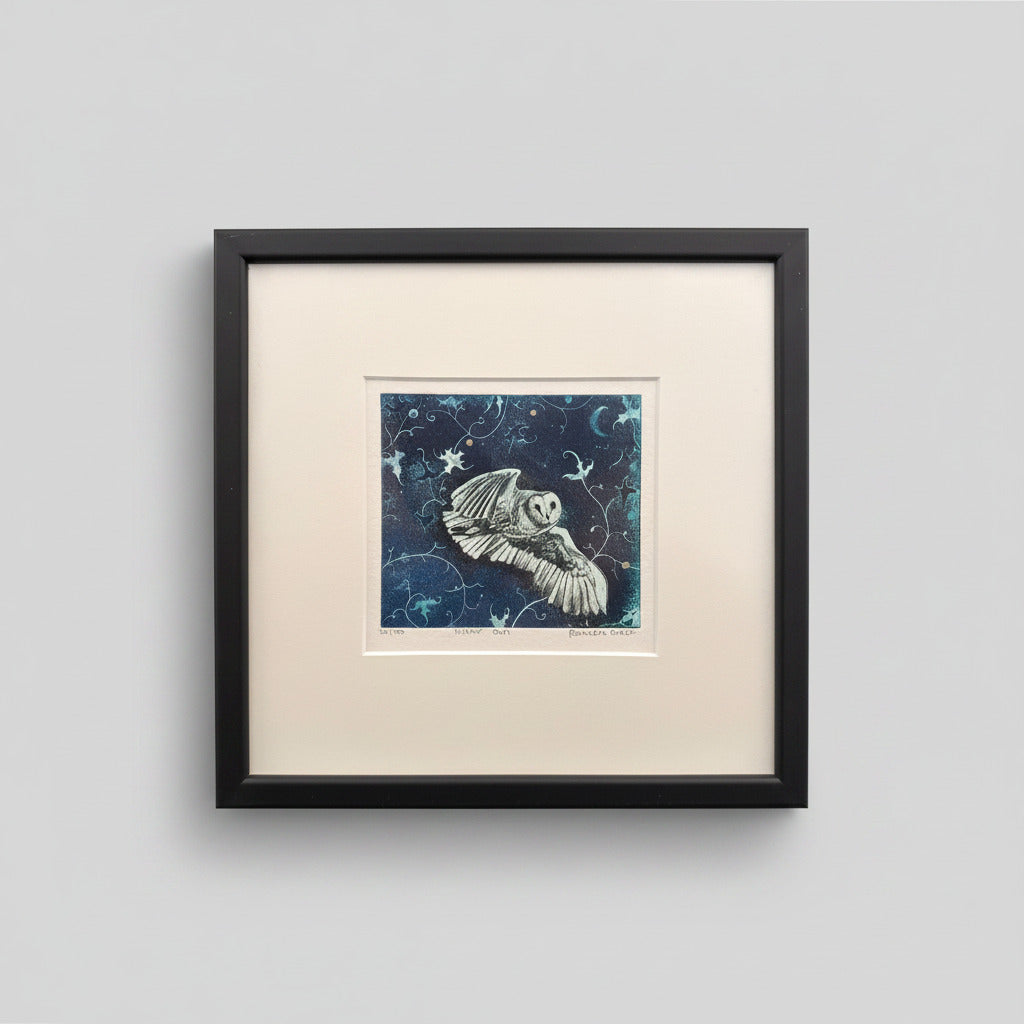 Framed artwork of an owl with a starry night background on a light gray wall.