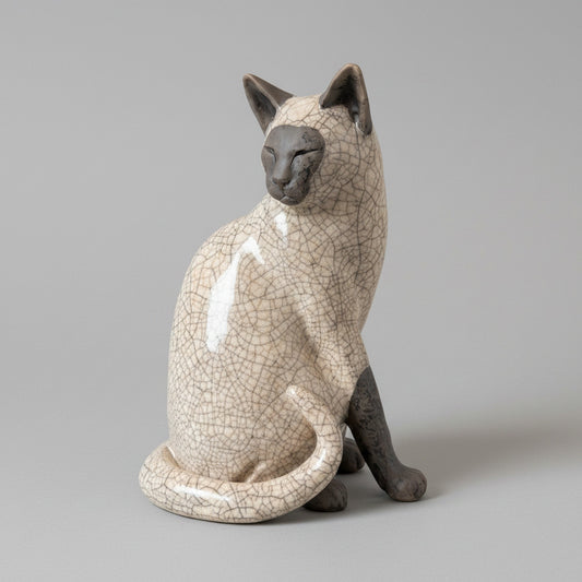 Ceramic cat figurine with a textured surface on a white surface.