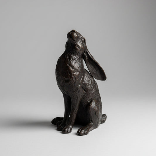 Black hare figurine on a textured white surface