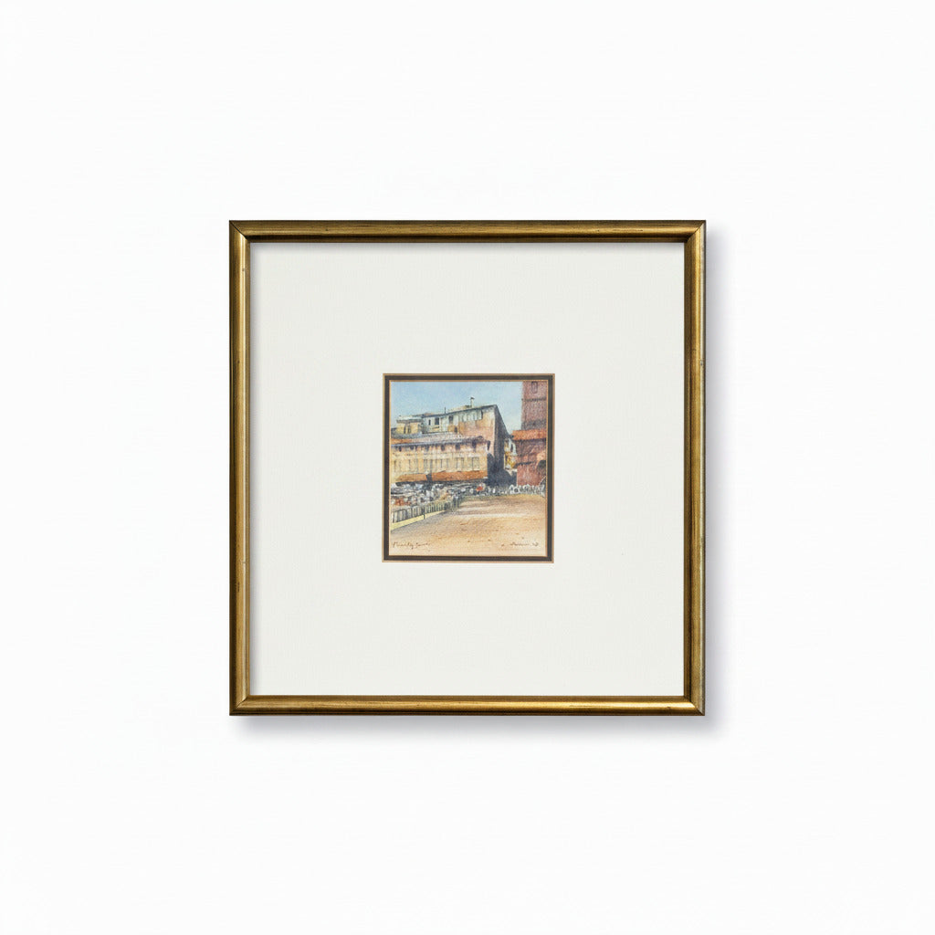 Framed artwork of a cityscape on a textured wall