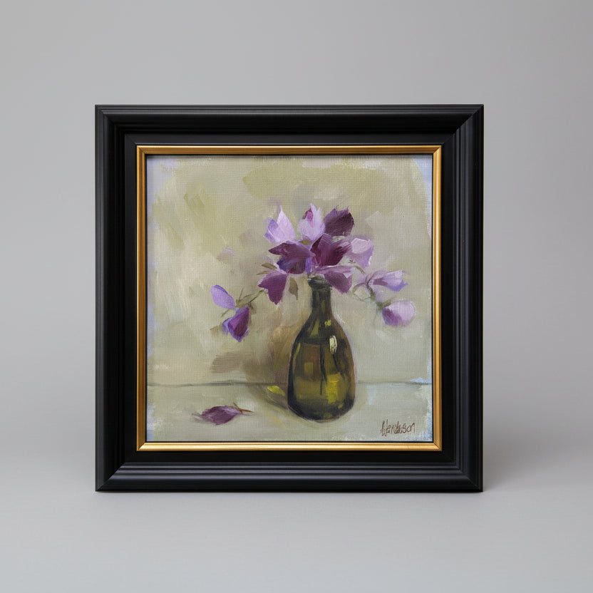 Painting of a vase with purple flowers on a beige background, framed in black with gold trim.