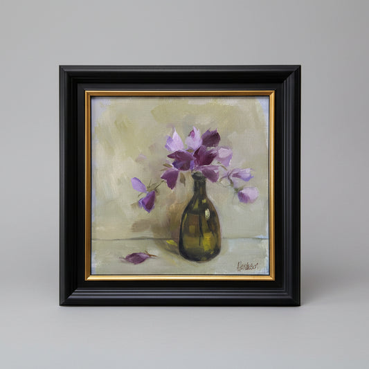Painting of a vase with purple flowers on a beige background, framed in black with gold trim.