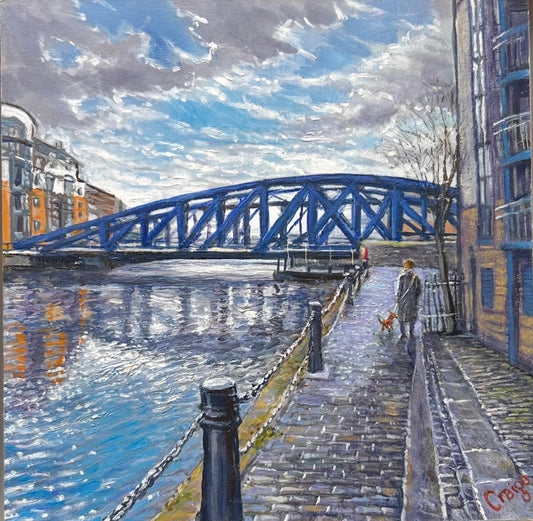 a painting of a canal with a blue swing bridge across it. there is also a figure walking with a dog.