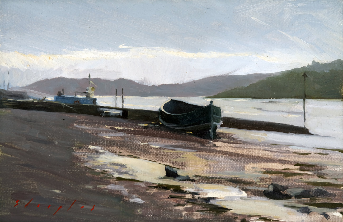 Boats on a beach with mountains in the background