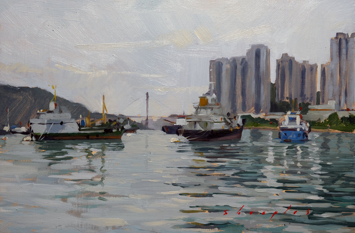 Harbor scene with boats and modern buildings in the background