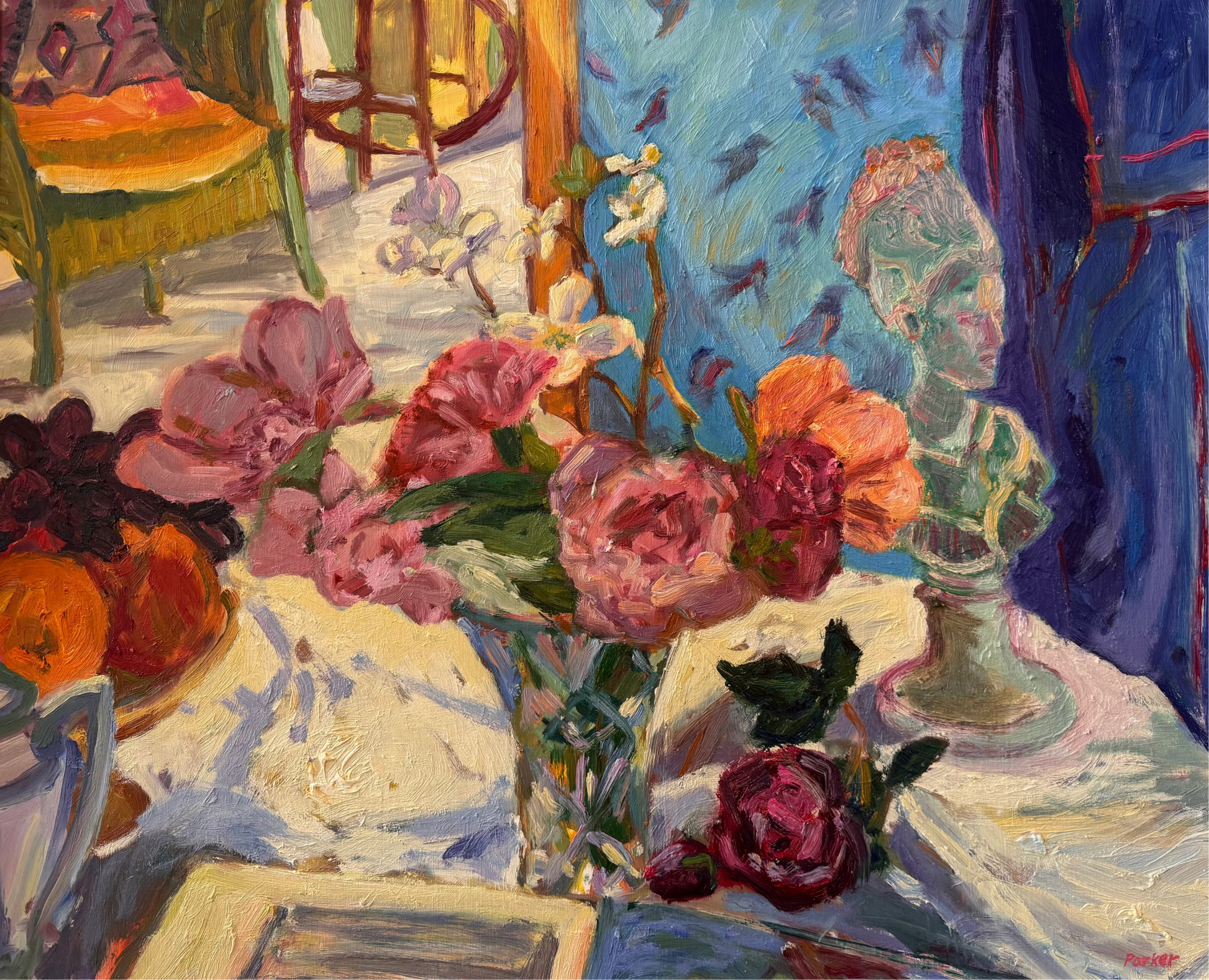 A framed oil painting depicting a still life of pink and red roses in a vase on a table, with a blue background and a gold-toned frame.
