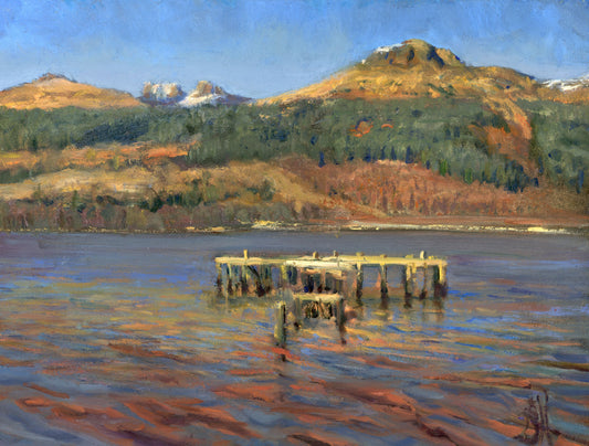 An impressionistic landscape painting of a calm lake with a weathered wooden pier in the foreground, forested hills, and mountains under a blue sky.