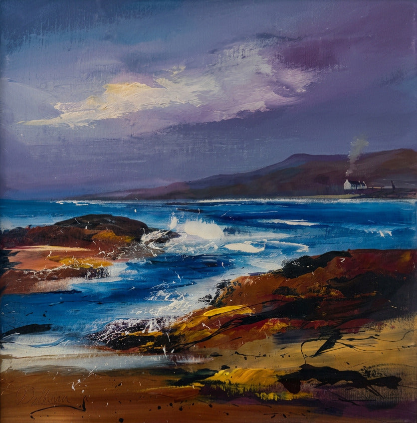 A framed coastal landscape painting showing blue ocean waves, rocky shoreline, distant hills, and a dramatic purple sky.