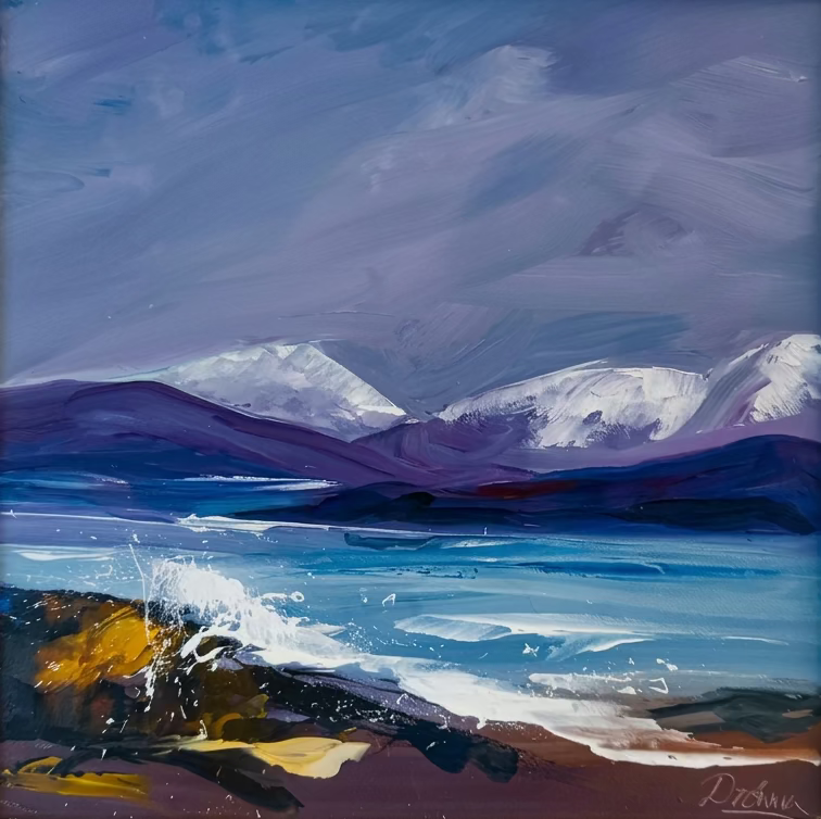 A framed landscape painting depicting snowy mountains, blue water, and a dark rocky shore with white surf, set in a light-colored wooden frame.