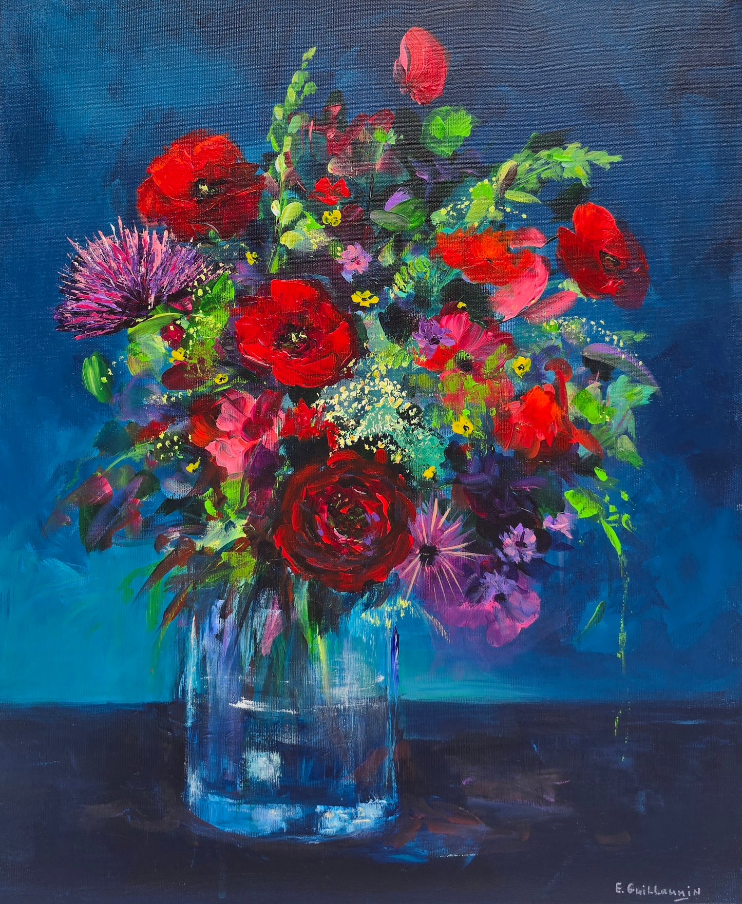 Colorful bouquet of flowers in a clear vase against a dark blue background