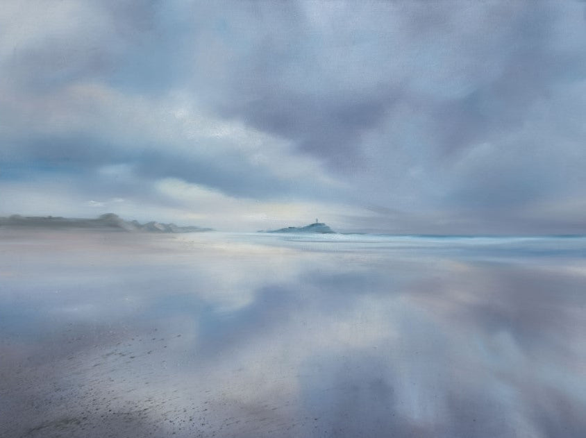 Reflective water surface with cloud reflections on a beach