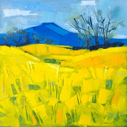An abstract landscape painting featuring a bright yellow field in the foreground, a deep blue mountain in the background, and dark leafless trees against a blue sky.