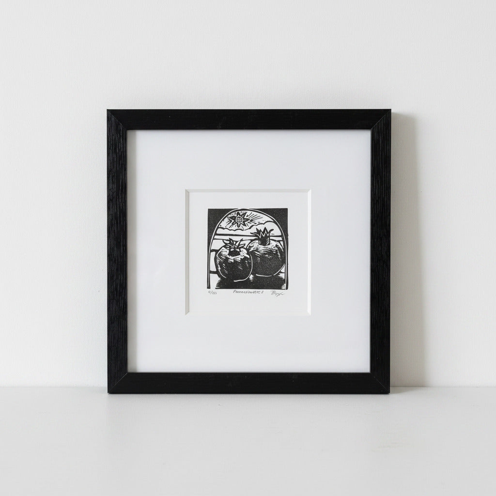 A framed black and white art print depicting two pumpkins under a starry sky, presented in a black frame with a white mat against a clean white background.