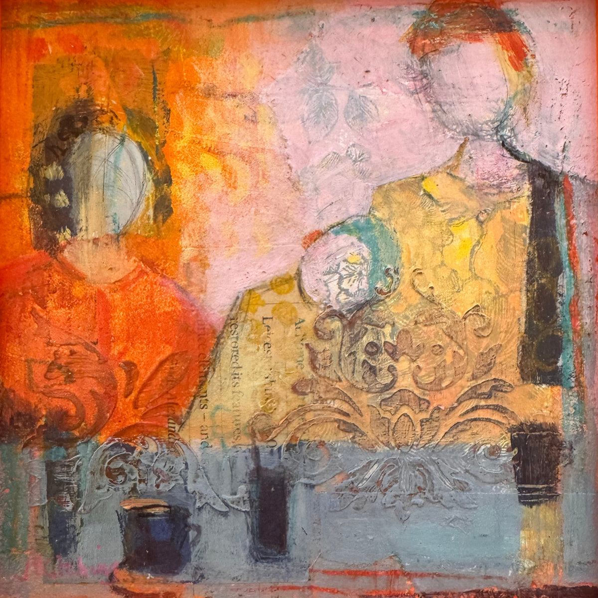 An abstract framed painting featuring two stylized human figures seated at a table, rendered in warm orange, yellow, pink, and blue tones with a vivid orange frame.