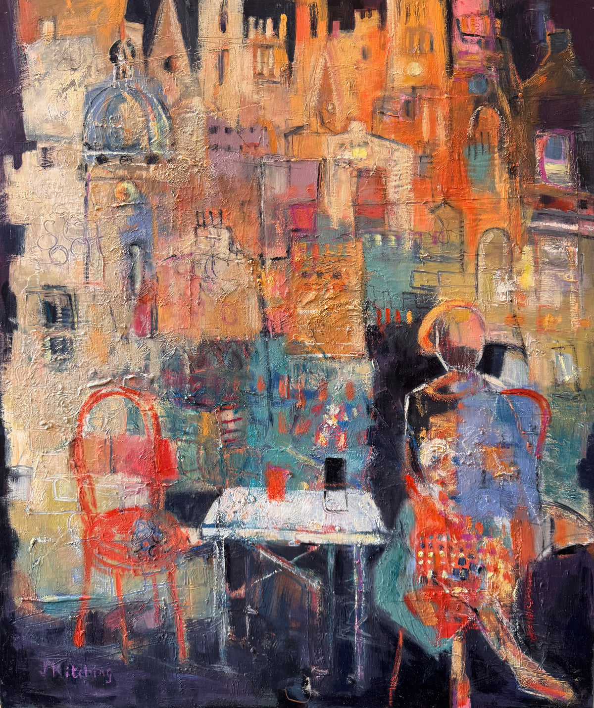 An expressive, textured oil painting of a Parisian cafe scene, featuring a seated figure in blue and red tones, red chairs, and a table, set against a dense background of warm-toned Parisian buildings. The painting is framed in white and displayed on an easel.